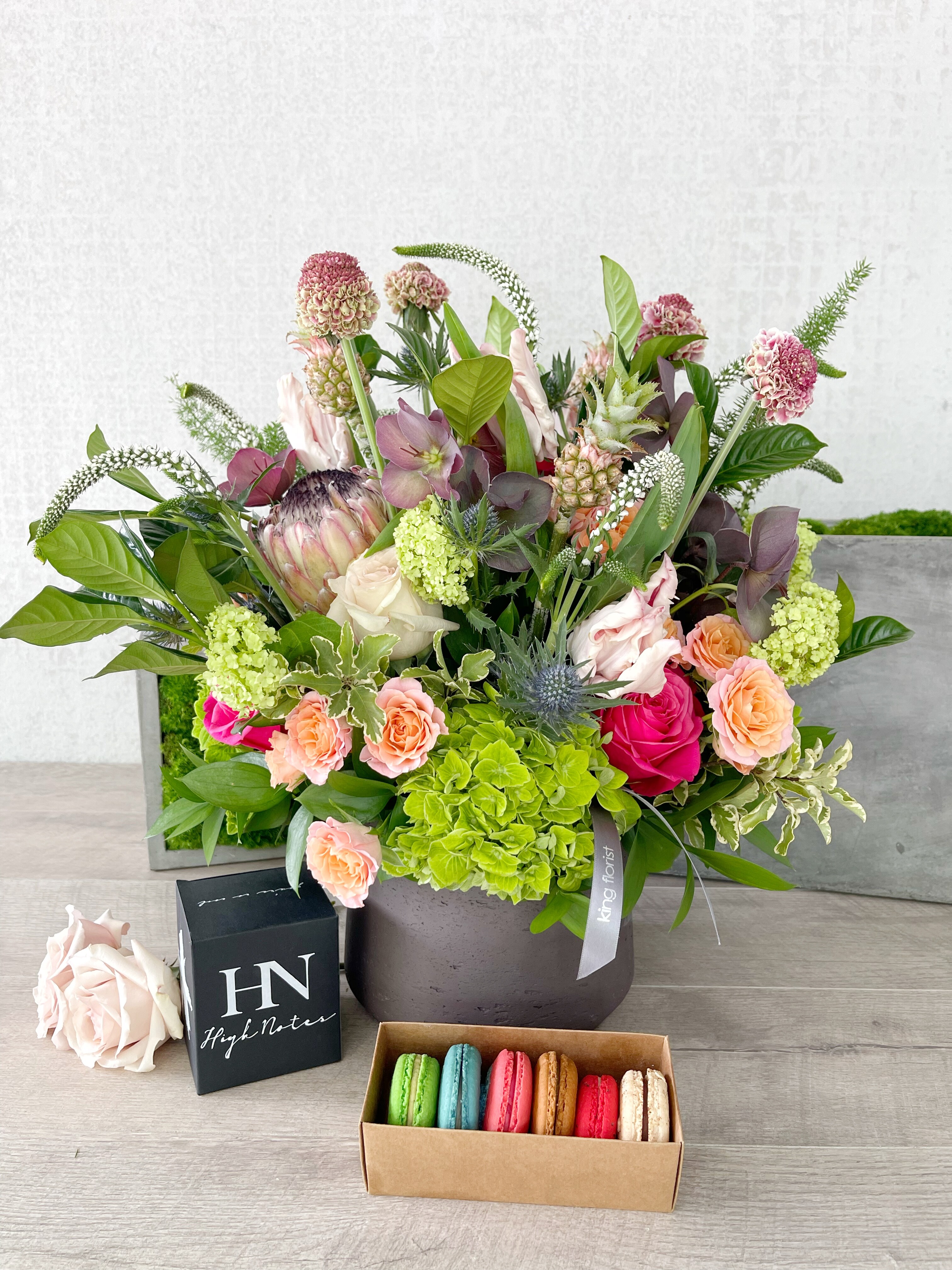 Floral Arrangement, Half Dozen Macarons, and Candle size, inches height and inches wide.