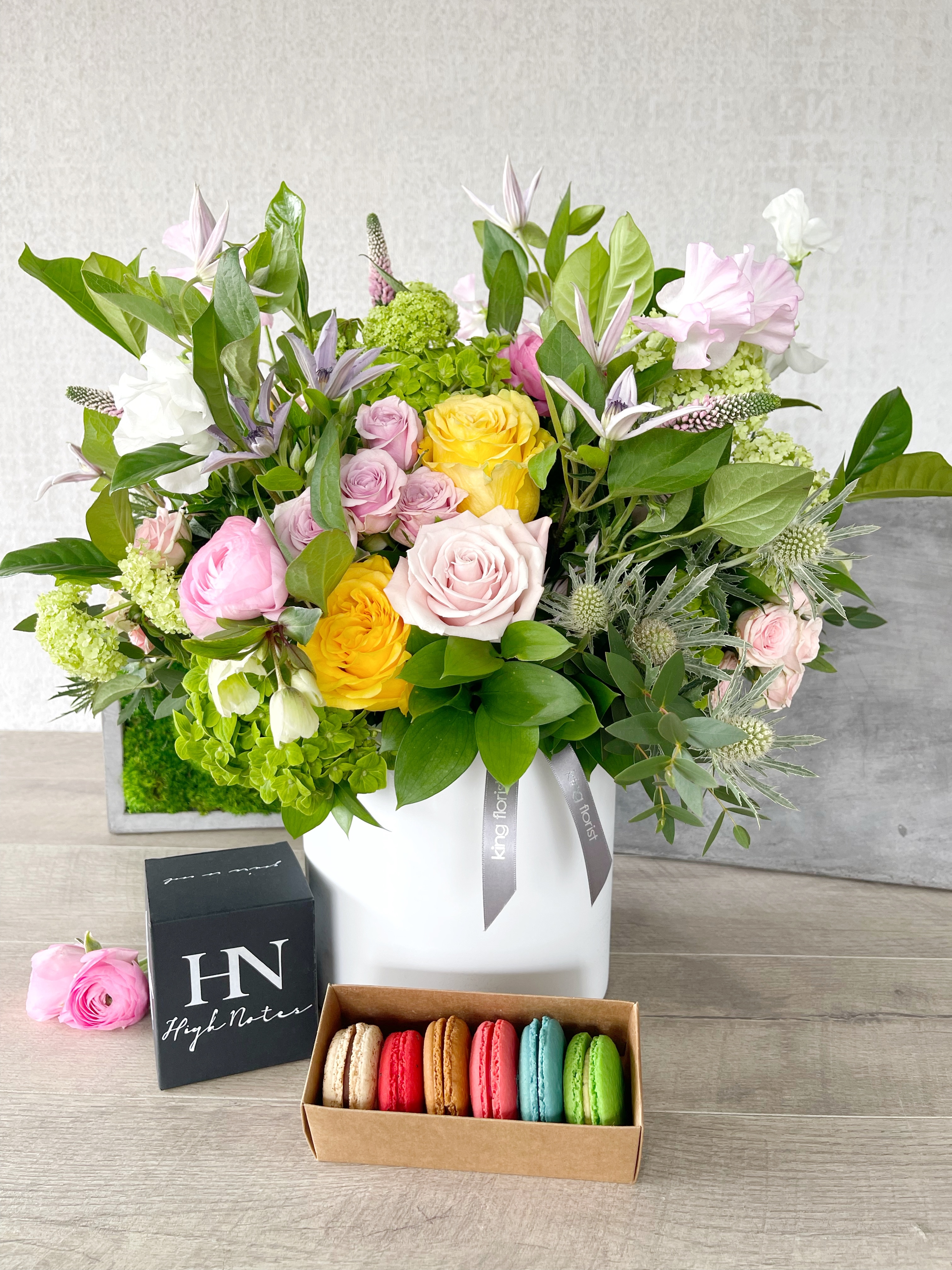 Floral Arrangement, Half dozen Macarons, and Candle size, inches height and inches wide.