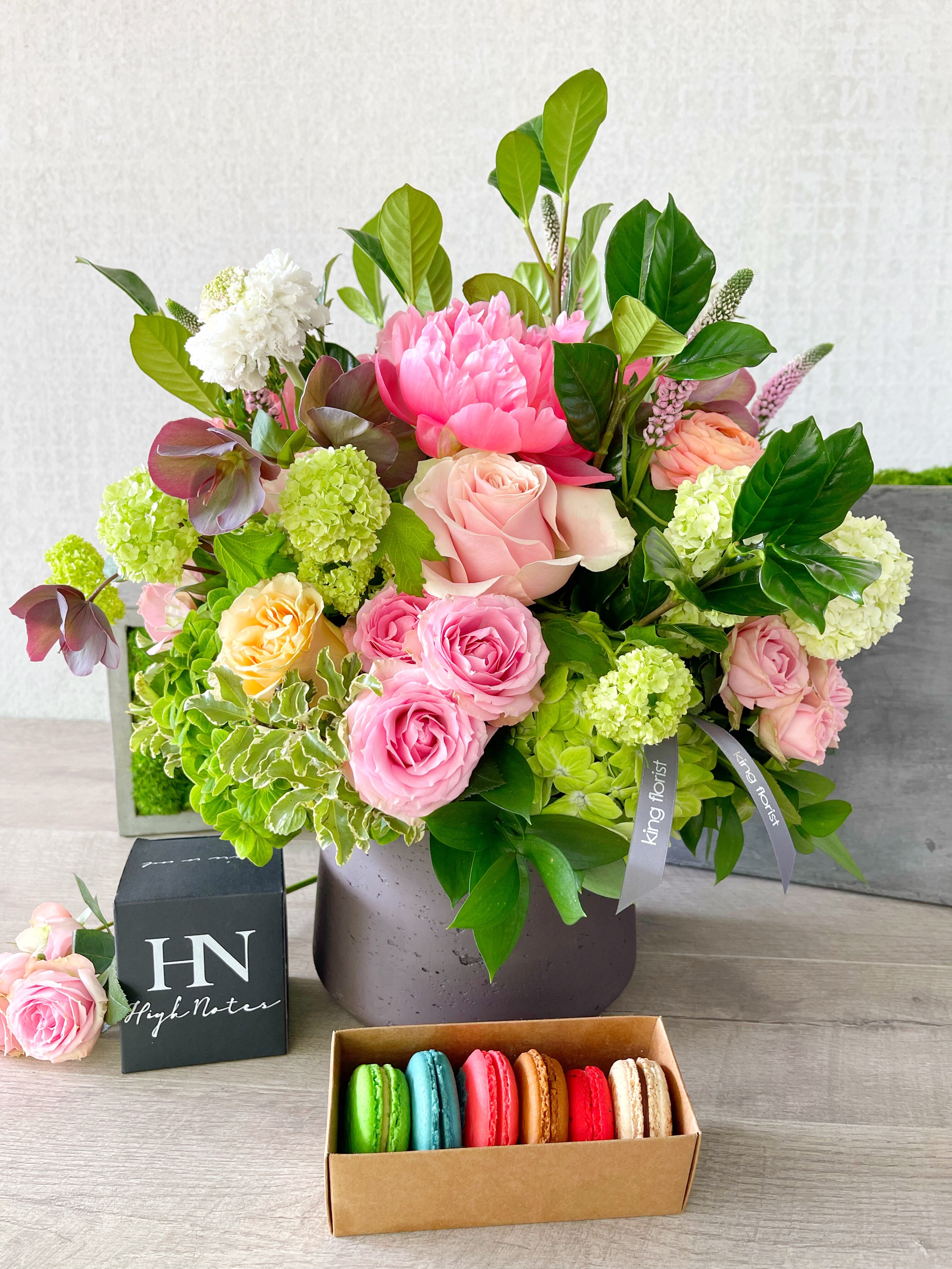 Floral Arrangement, Half dozen Macarons, and Candle size, inches height and inches wide.