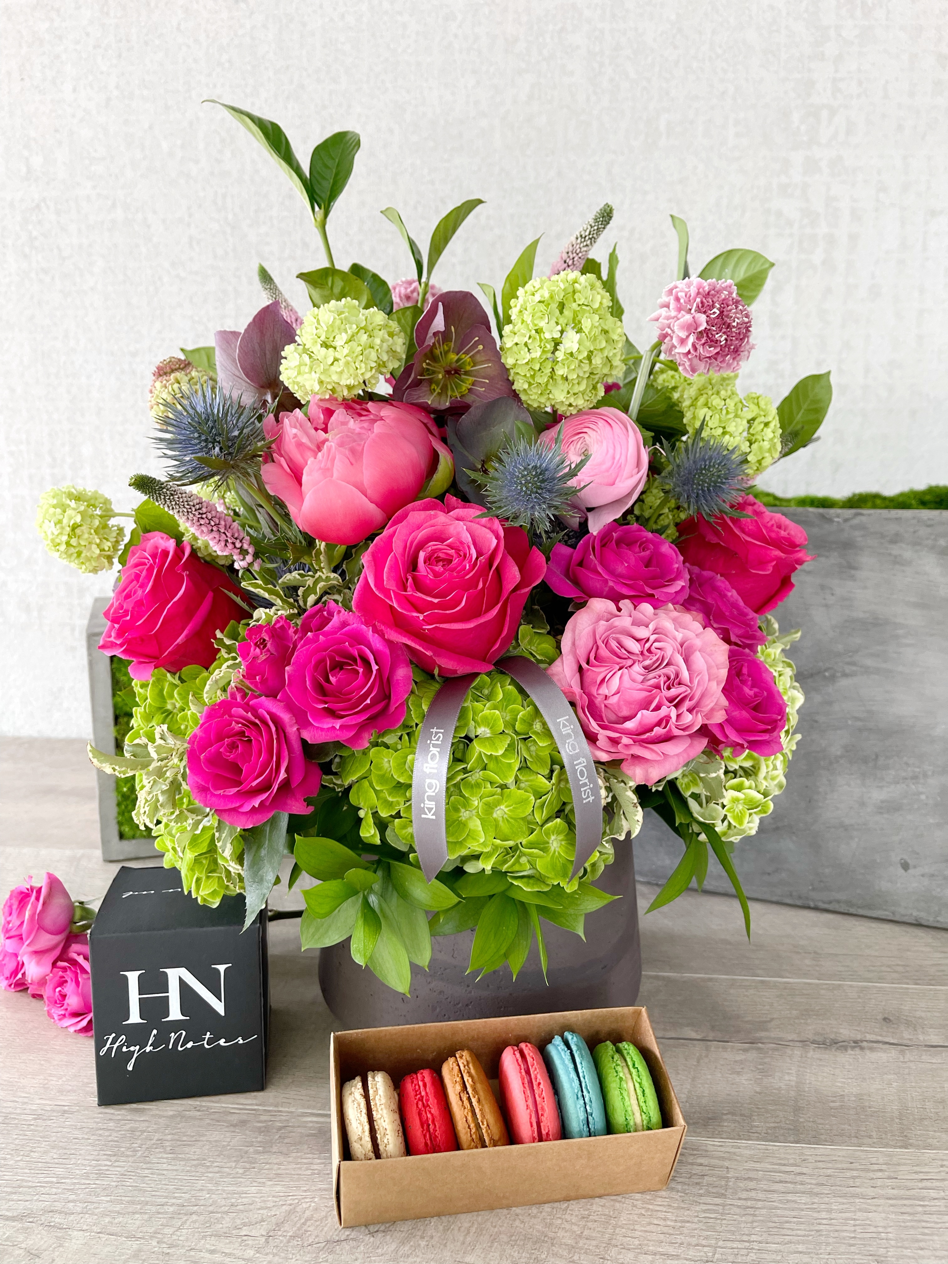 Floral Arrangement, Half dozen Macarons, and Candle size, inches height and inches wide.