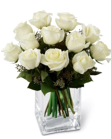 12 White Roses in a contemporary square vase size, inches height and inches wide.