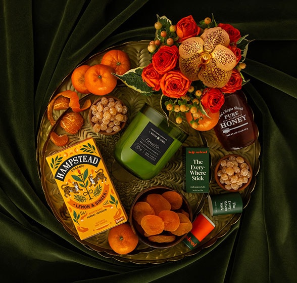 A styled assortment of cookies, crackers, popcorn, and candy with touches of autumn greenery.