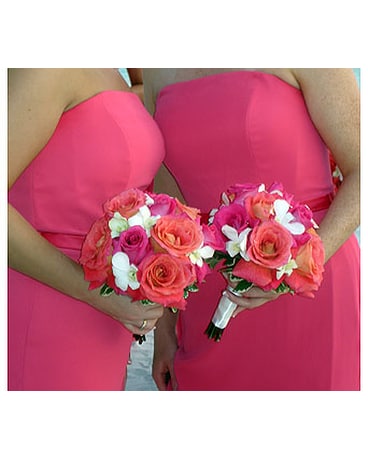 Coral, pink roses accented with white orchids