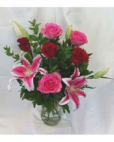 Mixed red and pink roses with stargazer lilies