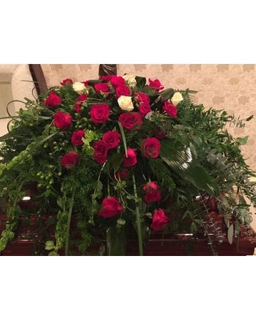 Legacy’s contemporary red rose and greens Funeral Casket Spray Flowers