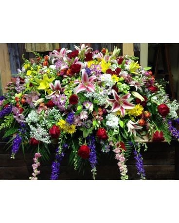 Legacy’s bold spring mix Funeral Casket Spray Flowers