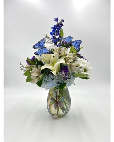 Image of Delphinium in a vase with a butterfly