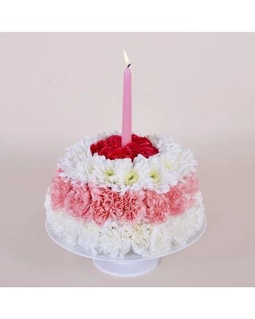 Premium AI Image | a birthday cake with purple flowers and a candle on a  table.