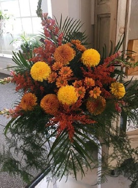large fall arrangement of snapdragons, chrysanthemums and daisies