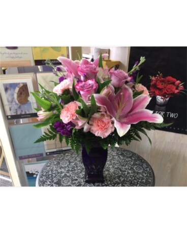 Lovely pink bouquet in dark purple vase by vivian