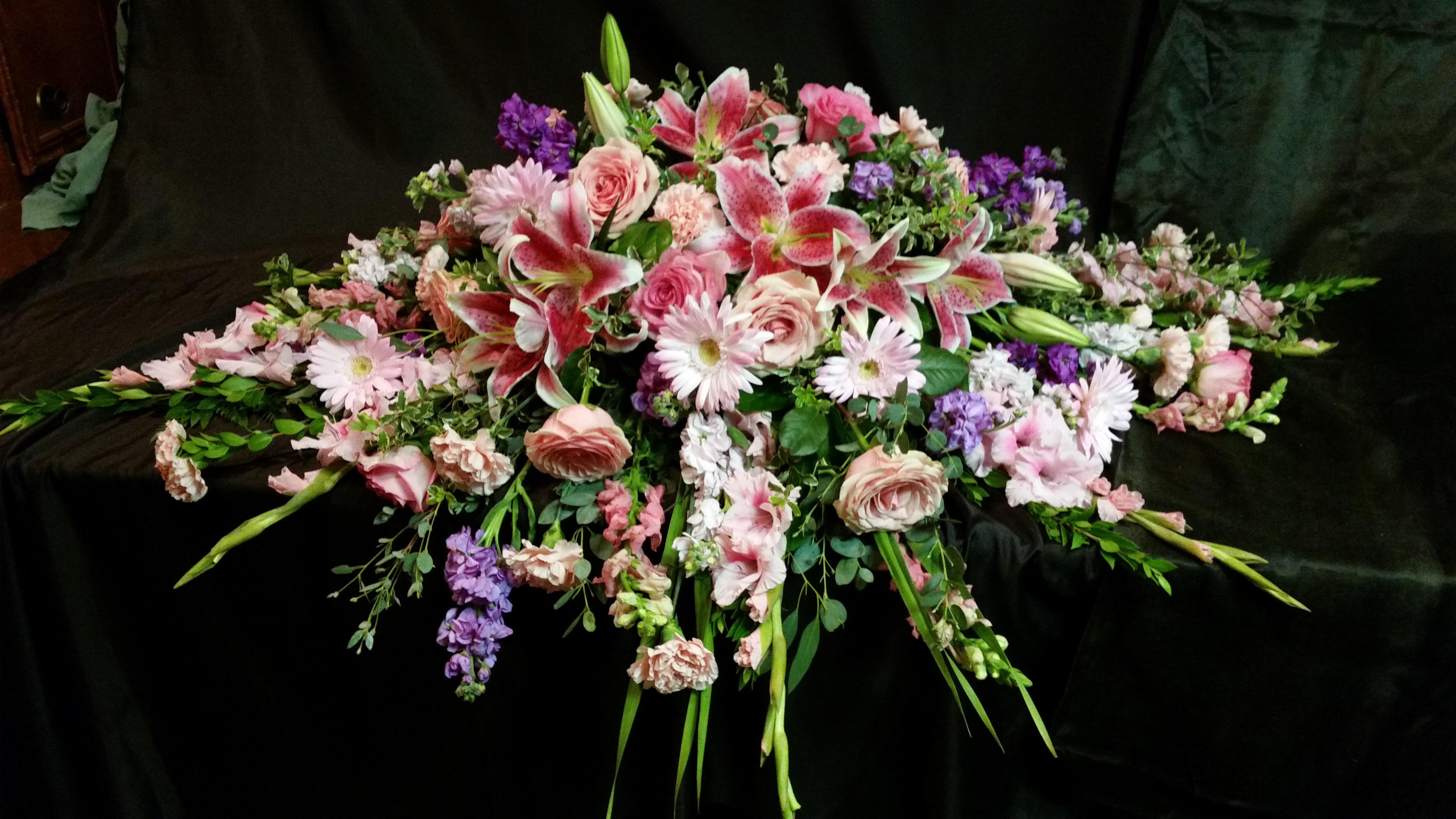 Draped In Pink Funeral Casket Spray Flowers