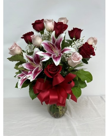 V246 Dozen Red & Pink roses with Stargazers Flower Arrangement