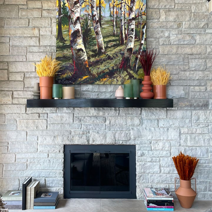 fireplace and mantle decorated with plants