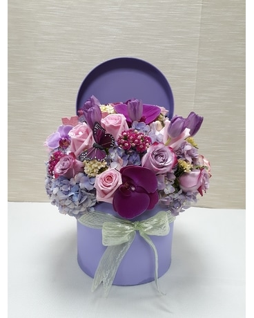 A Brilliant Assortment of Flowers in a Round Box Flower Arrangement