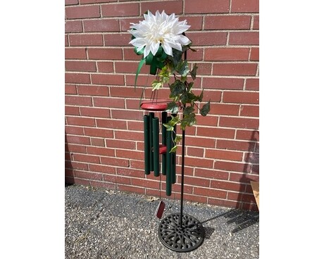 Wind chime on garden with Silk Flowers Flower Arrangement